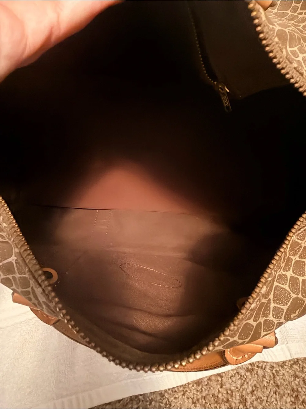 Nina Ricci Brown Patterned Duffel with Tan Trim. Has lock and key.
